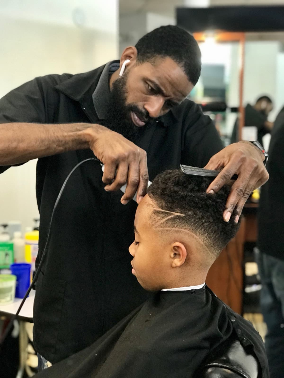 Garland Ingram, master barber and owner of Garland Cuts, giving a precision fade in his private suite at Full Circle Salon & Suites in Suwanee, GA